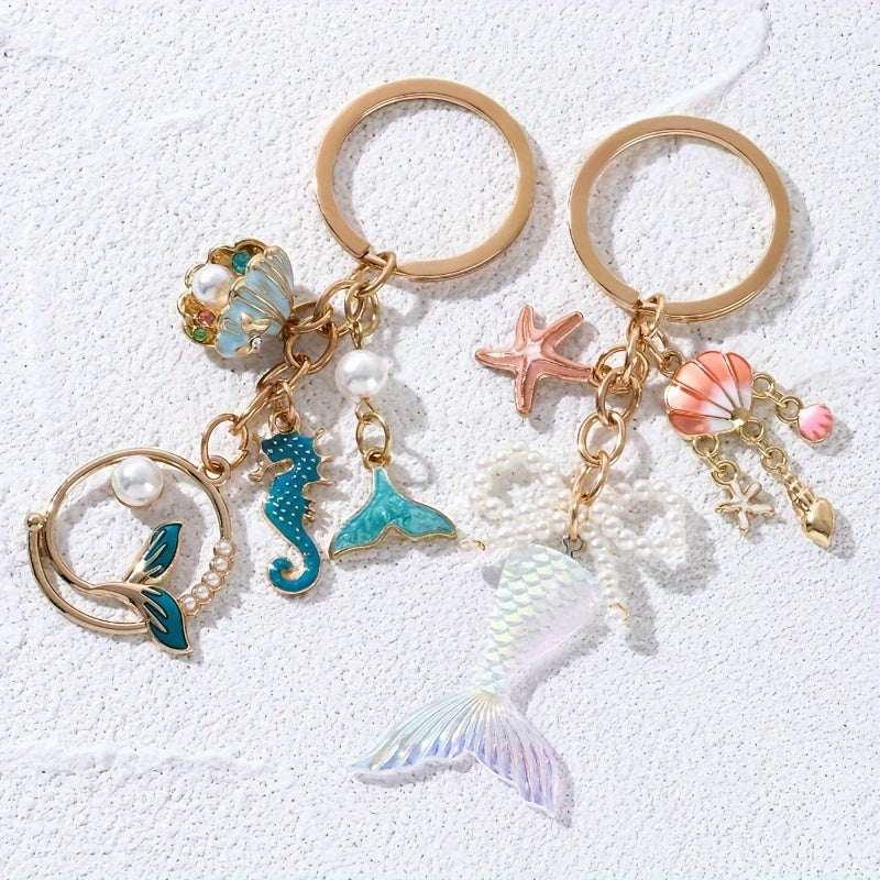 1 Stück sommerlicher Damen Schlüsselanhänger mit Seestern, Muschel, Mermaid-Flosse, Perlen oder Seestern – zwei sommerliches Designs in Gold, Weiß, Türkis oder Rosa
